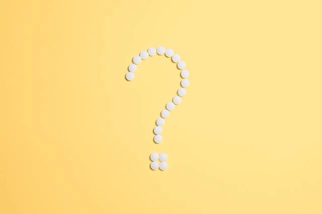 An interrogation sign on a yellow background