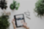 Tablet surrounded by plants