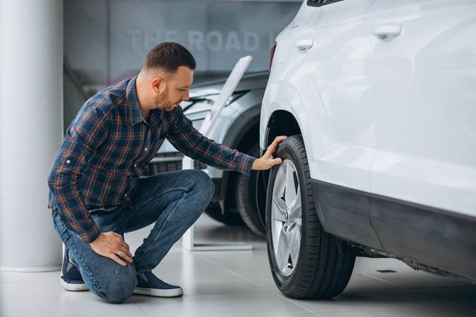 Person to check tire pressure